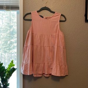 Blush, semi-babydoll tank top blouse. Polyester and spandex